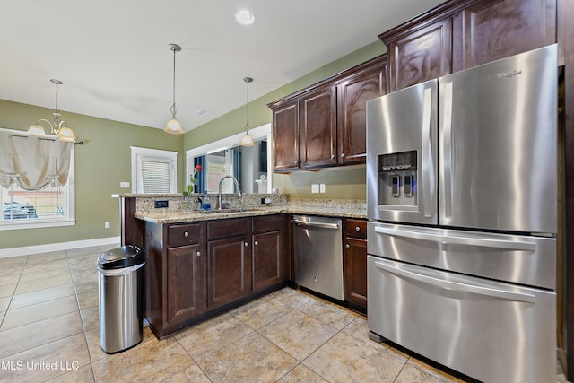 18225 Tulip Cv, Gulfport, MS 39503 - kitchen with appliances with stainless steel finishes, a sink, light tile patterned flooring, and a peninsula