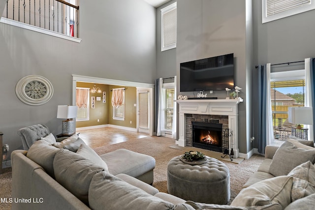 18225 Tulip Cv, Gulfport, MS 39503 - living area featuring a towering ceiling, plenty of natural light, a fireplace, and baseboards