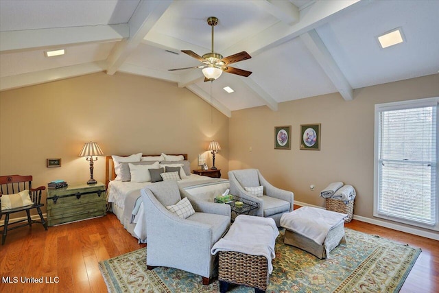 bedroom with ceiling fan, wood-type flooring, and lofted ceiling with beams