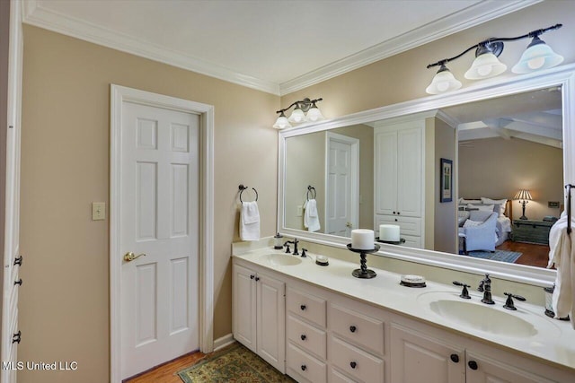 bathroom featuring ornamental molding, vanity, and hardwood / wood-style floors