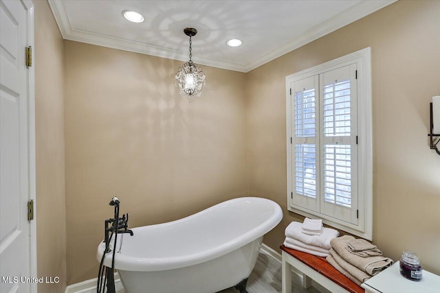 bathroom with a tub to relax in and ornamental molding