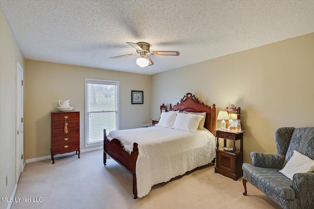 carpeted bedroom featuring a textured ceiling and ceiling fan