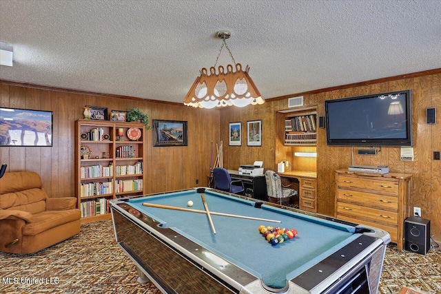 recreation room featuring ornamental molding, pool table, a textured ceiling, and dark carpet