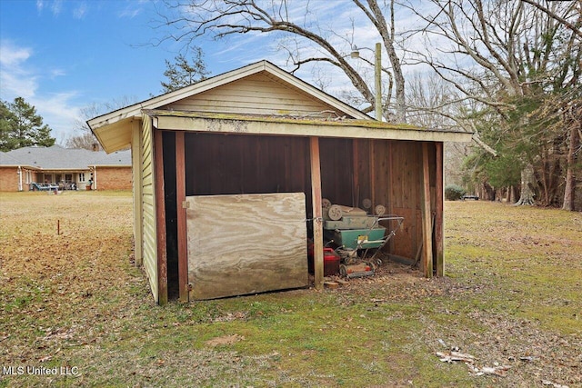 view of outbuilding with a yard