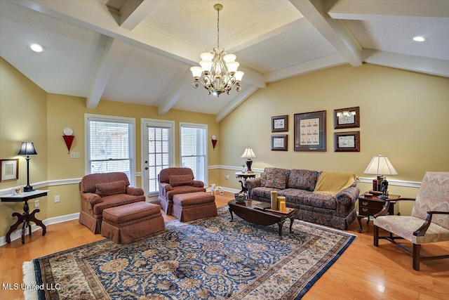 living room featuring hardwood / wood-style flooring, vaulted ceiling with beams, a textured ceiling, and a chandelier