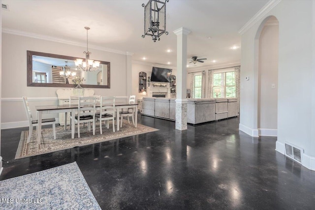 dining space with baseboards, a fireplace, ceiling fan with notable chandelier, and visible vents