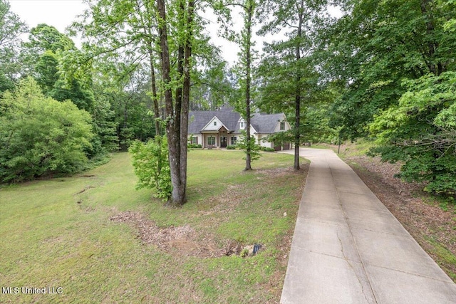 view of front of home featuring driveway and a front lawn