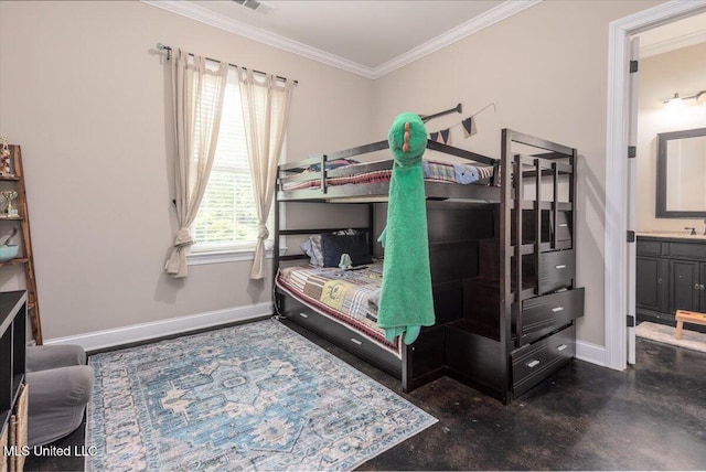 bedroom with crown molding, baseboards, and ensuite bathroom