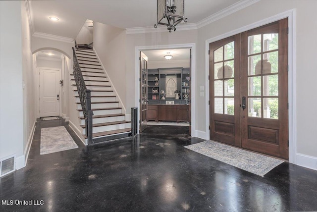entryway featuring arched walkways, baseboards, visible vents, and french doors