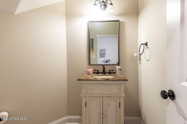 bathroom with baseboards and vanity