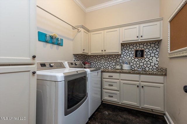 clothes washing area with washer and dryer, ornamental molding, and cabinet space