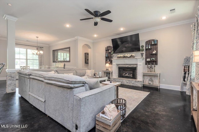 living room with a high end fireplace, crown molding, baseboards, ceiling fan with notable chandelier, and recessed lighting