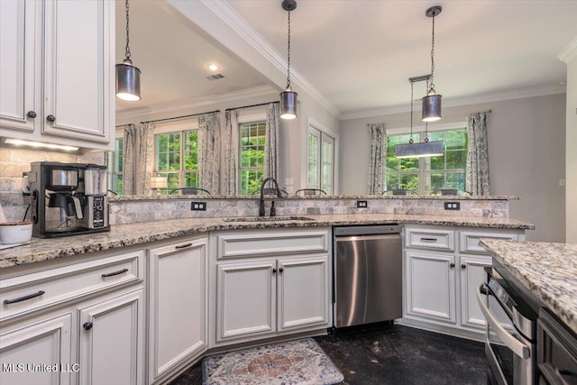 kitchen with a sink, appliances with stainless steel finishes, a healthy amount of sunlight, and tasteful backsplash