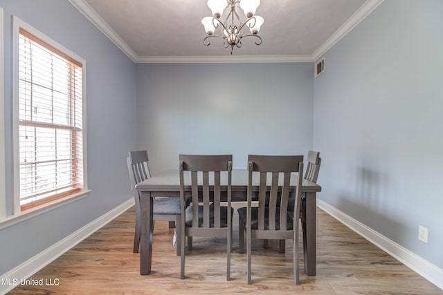 dining space with hardwood / wood-style flooring, a chandelier, and a wealth of natural light