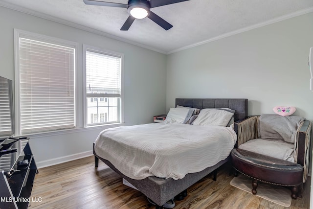 bedroom with ornamental molding, a textured ceiling, wood-type flooring, and ceiling fan