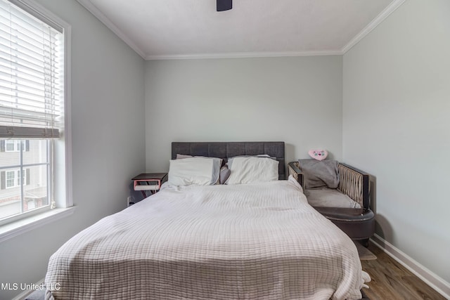 bedroom with ornamental molding, dark hardwood / wood-style floors, and ceiling fan