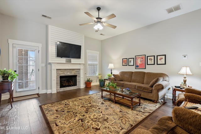 living room featuring ceiling fan and dark hardwood / wood-style flooring