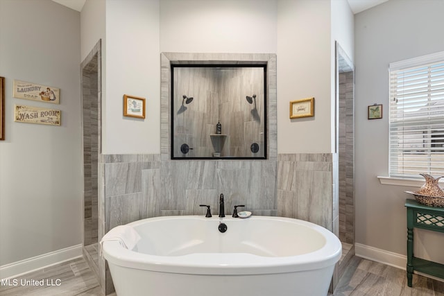 bathroom featuring tile walls, independent shower and bath, wood-type flooring, and plenty of natural light