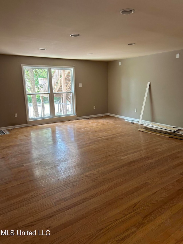 unfurnished room featuring hardwood / wood-style flooring