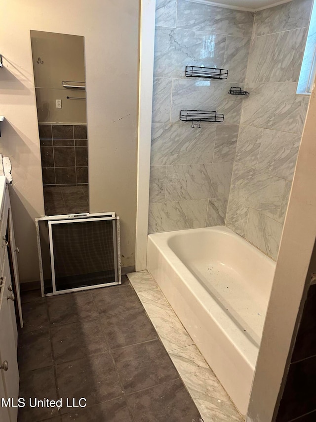 bathroom with tile walls, vanity, and tiled shower / bath combo