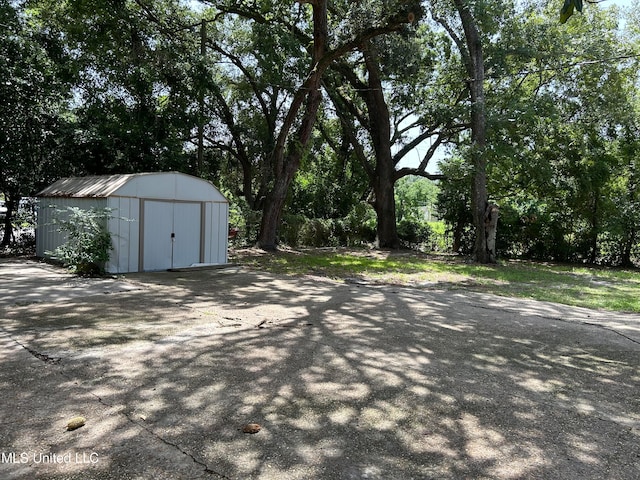 view of patio with a storage shed