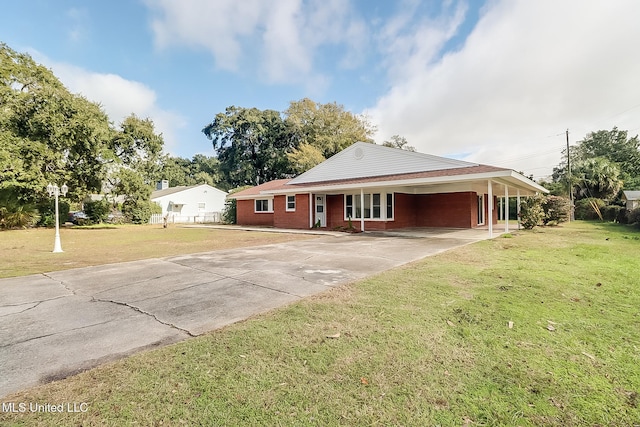 view of front of property with a front yard and a carport