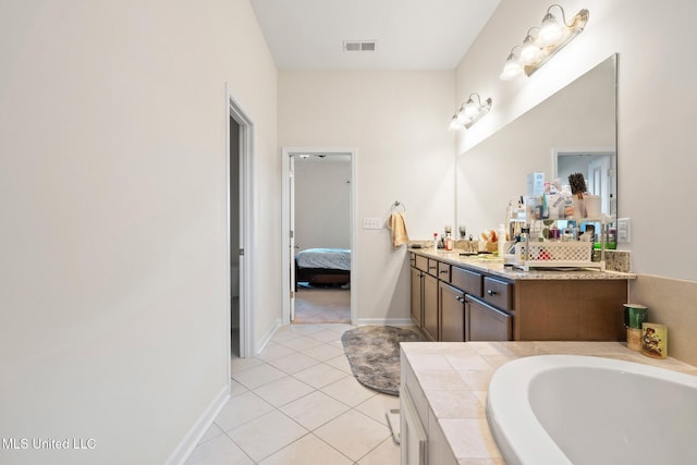 7785 Parkridge Dr, Southaven, MS 38671 - ensuite bathroom with a garden tub, vanity, tile patterned flooring, and baseboards