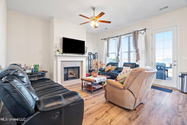 7785 Parkridge Dr, Southaven, MS 38671 - living room with a ceiling fan, light wood finished floors, and a tile fireplace