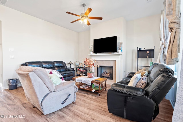 7785 Parkridge Dr, Southaven, MS 38671 - living room featuring light wood-style floors, a ceiling fan, a fireplace, and baseboards