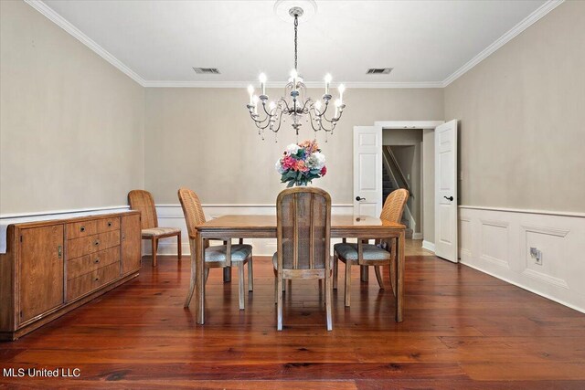 dining room featuring a notable chandelier, crown molding, and dark hardwood / wood-style flooring