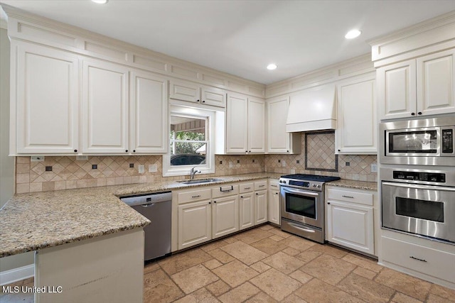 kitchen with kitchen peninsula, tasteful backsplash, white cabinetry, custom range hood, and stainless steel appliances