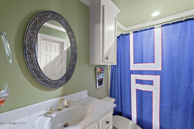 bathroom featuring vanity, toilet, crown molding, and a shower with shower curtain