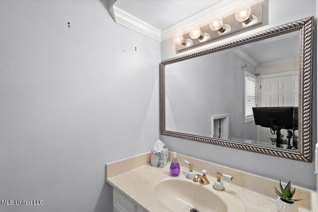 bathroom with vanity and crown molding