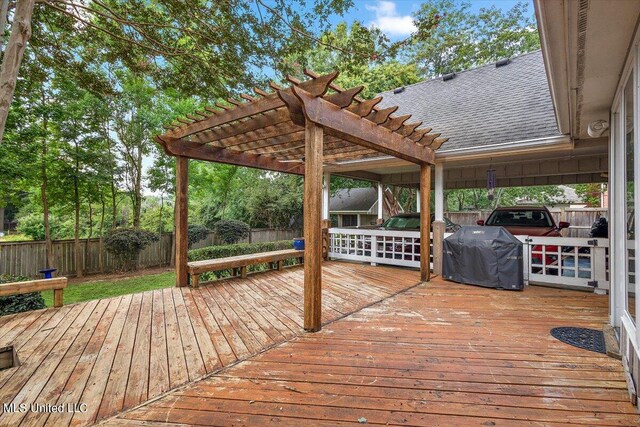 wooden terrace featuring a grill and a pergola