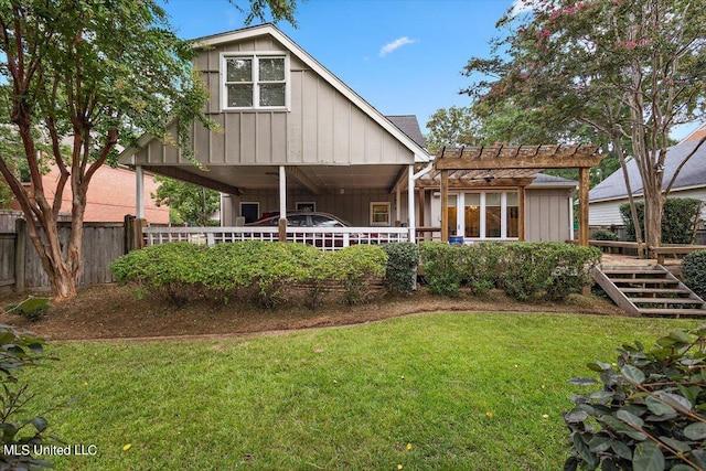 back of house featuring a yard and a pergola