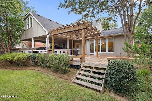 rear view of house with a yard, a wooden deck, and a pergola