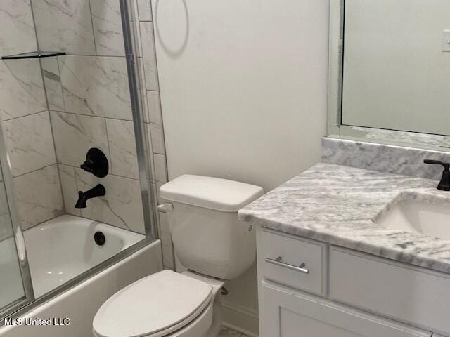 full bathroom featuring vanity, toilet, and enclosed tub / shower combo