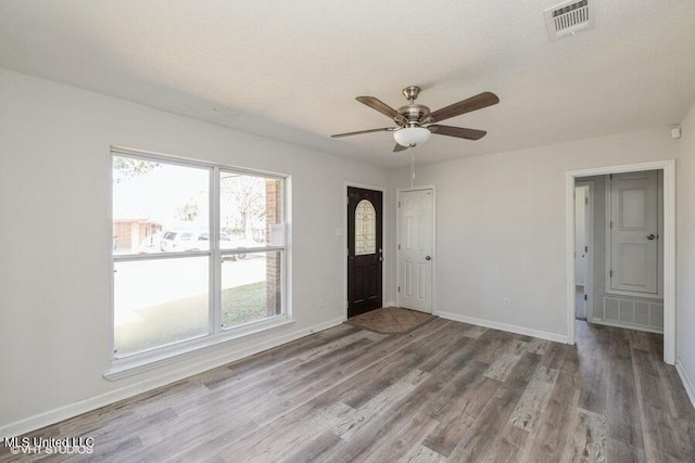 entrance foyer with visible vents, wood finished floors, baseboards, and ceiling fan