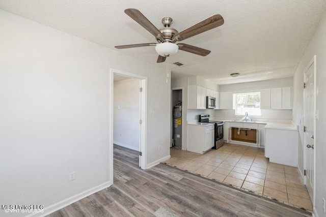 kitchen featuring a ceiling fan, visible vents, light countertops, appliances with stainless steel finishes, and white cabinetry