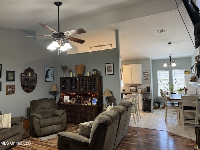 9958 Kahana St, Diamondhead, MS 39525 - living area with ceiling fan, light wood-style flooring, and a chandelier