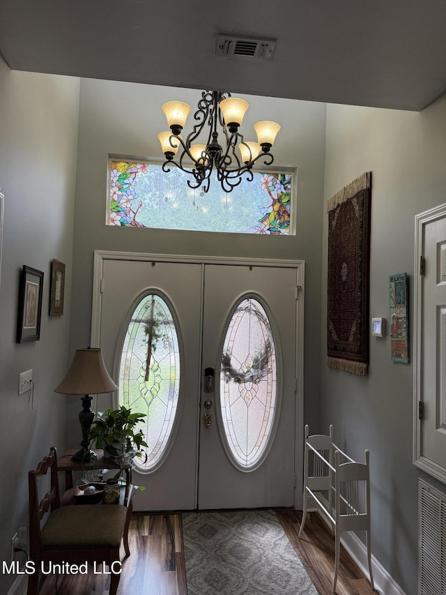 9958 Kahana St, Diamondhead, MS 39525 - foyer entrance featuring a chandelier, wood finished floors, and french doors