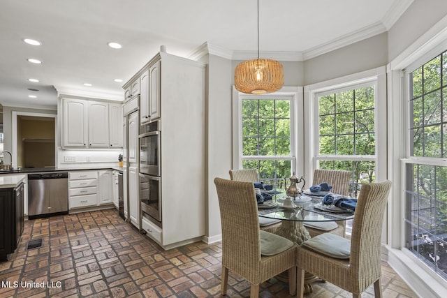 435 Glenway Dr, Jackson, MS 39216 - kitchen featuring brick floor, hanging light fixtures, ornamental molding, stainless steel appliances, and recessed lighting