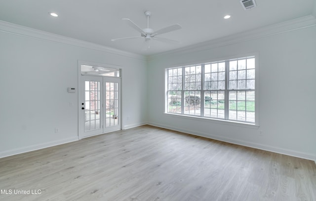 empty room featuring ceiling fan, light hardwood / wood-style floors, and crown molding