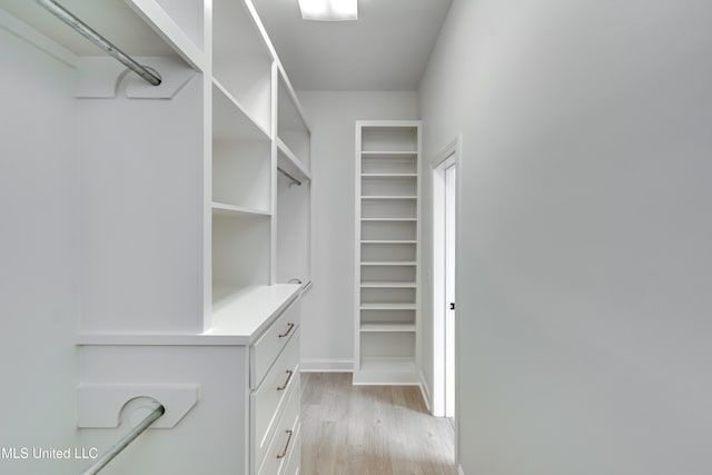 walk in closet featuring light hardwood / wood-style flooring