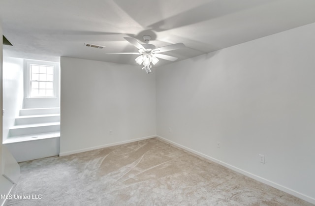 empty room with light carpet and ceiling fan