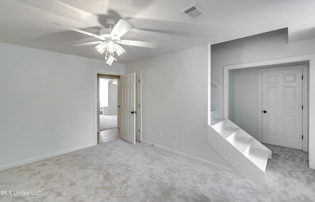 carpeted empty room featuring ceiling fan