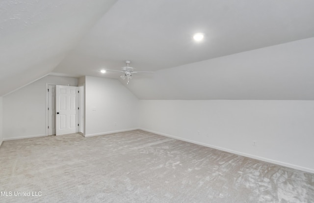 bonus room featuring light carpet, ceiling fan, and vaulted ceiling