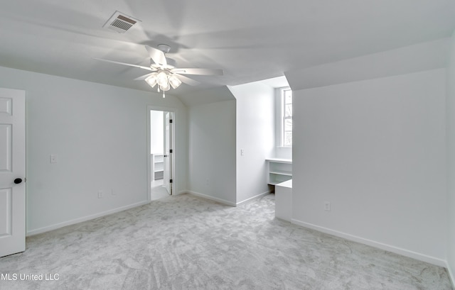 additional living space featuring lofted ceiling, ceiling fan, and light colored carpet