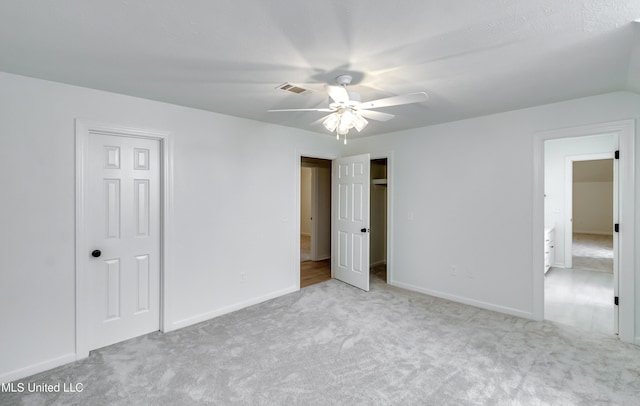 unfurnished bedroom featuring light colored carpet and ceiling fan