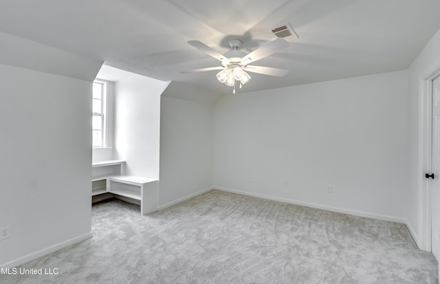 bonus room with light colored carpet and ceiling fan